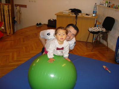 child on the ball with therapist