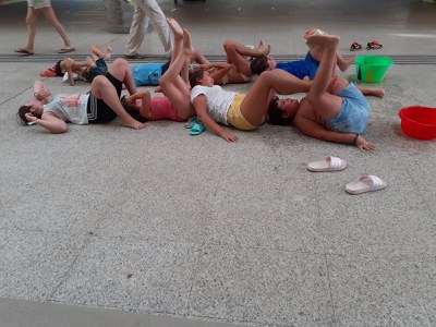 LYING ON THE FLOOR WE PASS A WET SPONGE WITH OUR FEET